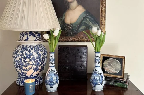 Tulips in a delft vases in front of an old master painting